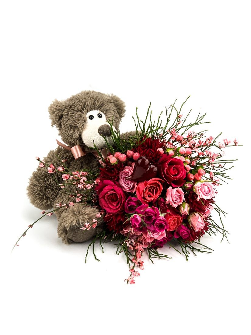 Bouquet of red -pink flowers, with a sweet teddy bear