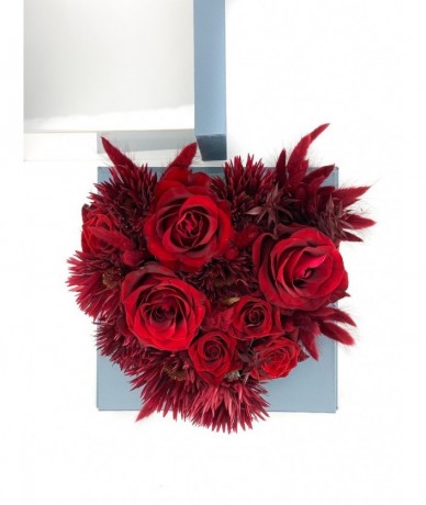 Red flowers in an elegant heart-shaped blue box with a drawer