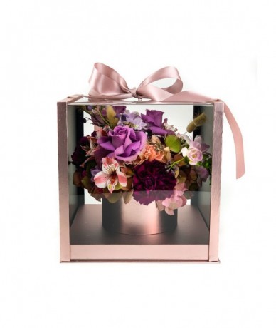 Luxurious rosé and transparent gift box with a small mixed bouquet