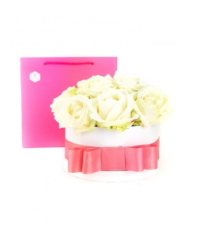 White roses in a white box with pink ribbon